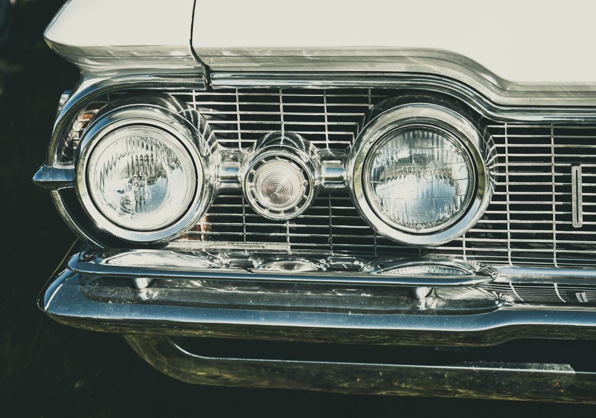 Chrome headlamps and grille of a classic car
