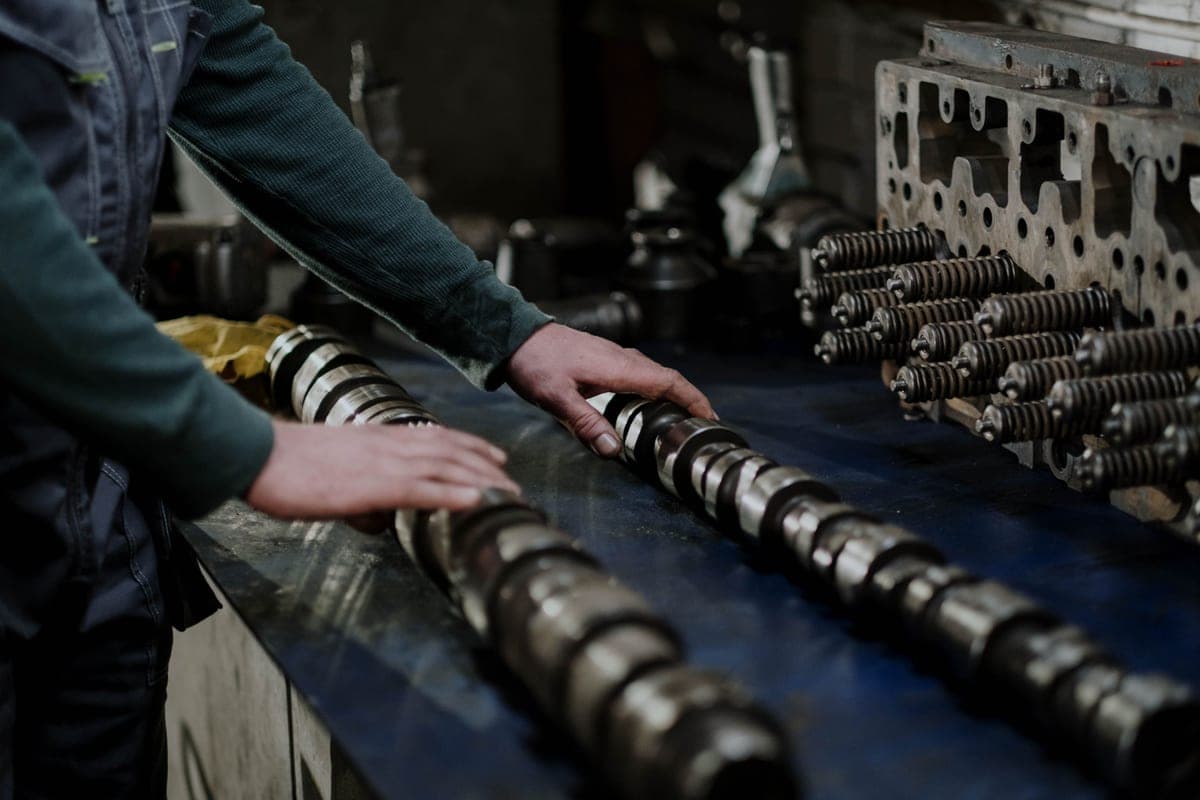 Camshafts and a cylinder head on a workshop bench