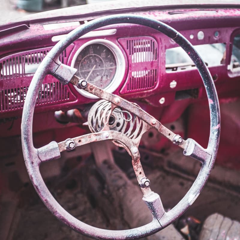 Weathered steering wheel of a car awaiting restoration